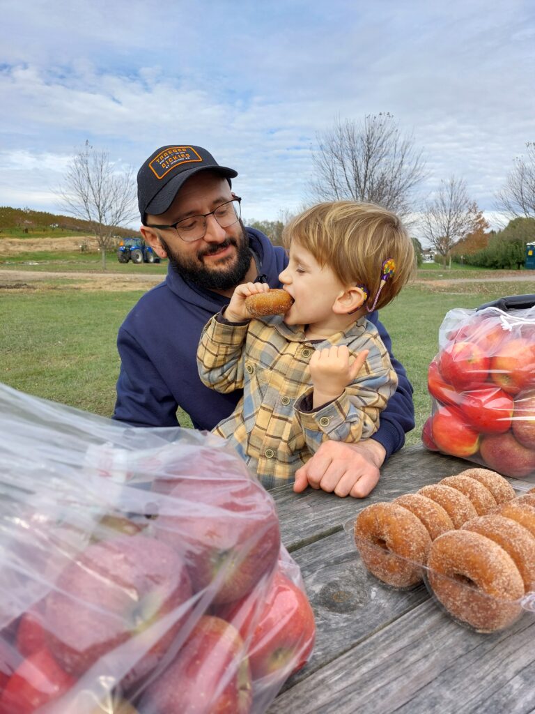boy eating donut with father